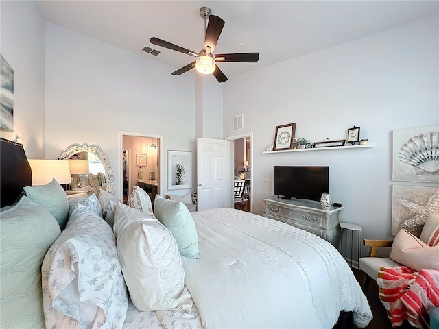 bedroom featuring high vaulted ceiling, ceiling fan, and ensuite bathroom