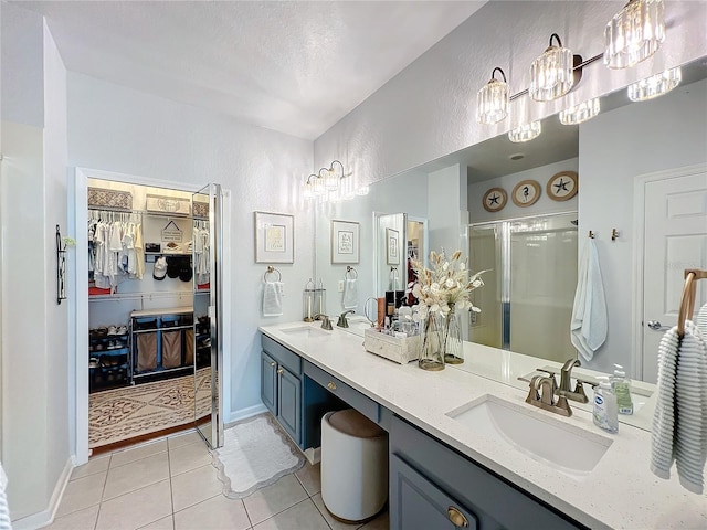 bathroom with tile patterned flooring, vanity, and a shower with shower door