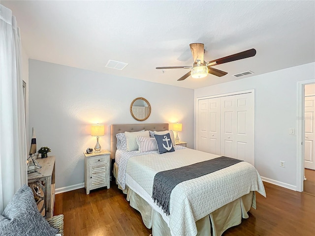 bedroom with dark hardwood / wood-style floors, ceiling fan, and a closet