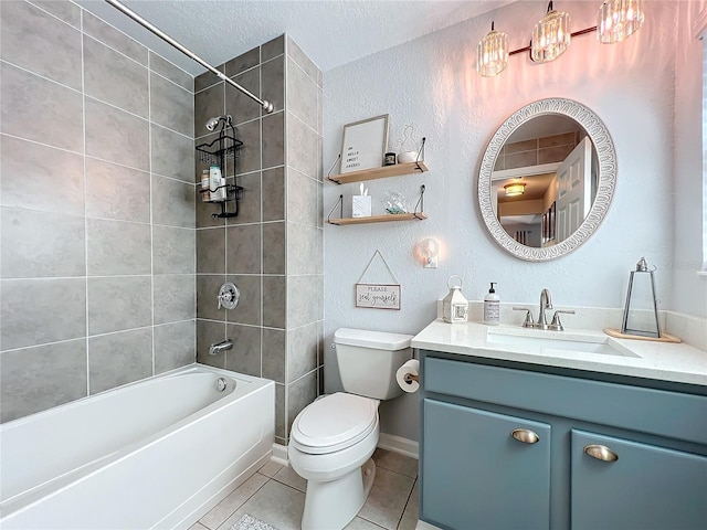 full bathroom with tiled shower / bath, vanity, toilet, tile patterned floors, and a textured ceiling