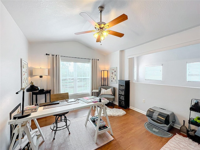 office area featuring vaulted ceiling, ceiling fan, hardwood / wood-style floors, and a textured ceiling