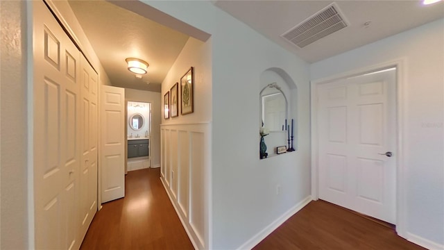 hallway with dark hardwood / wood-style flooring