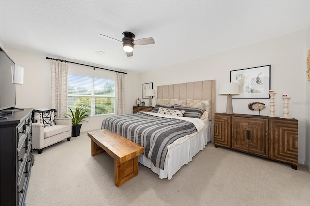 bedroom with light colored carpet and ceiling fan