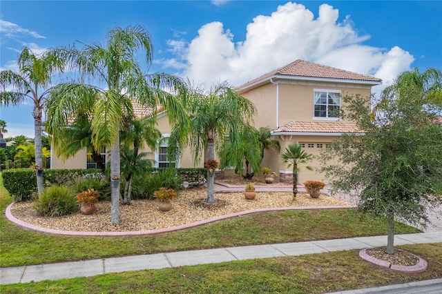 mediterranean / spanish-style house with a garage and a front lawn