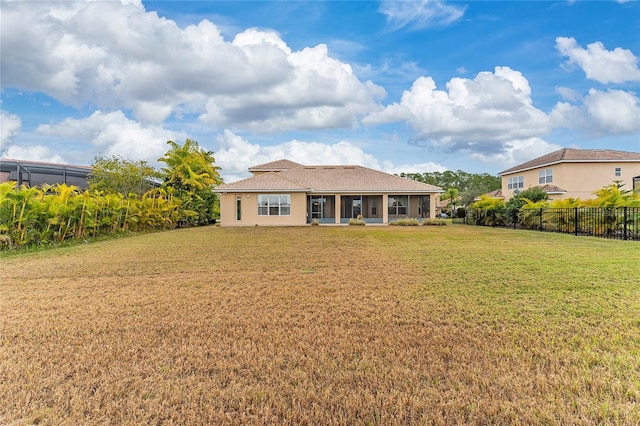 rear view of property with a yard