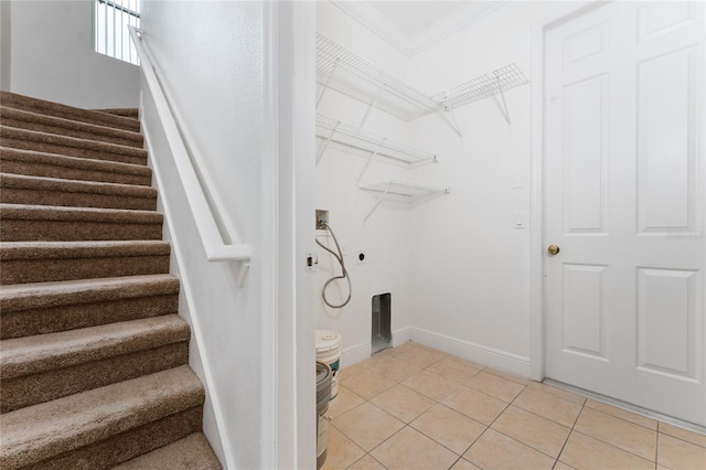 washroom with ornamental molding, electric dryer hookup, washer hookup, and light tile patterned floors