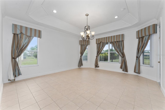 spare room featuring crown molding, a tray ceiling, light tile patterned floors, and a notable chandelier