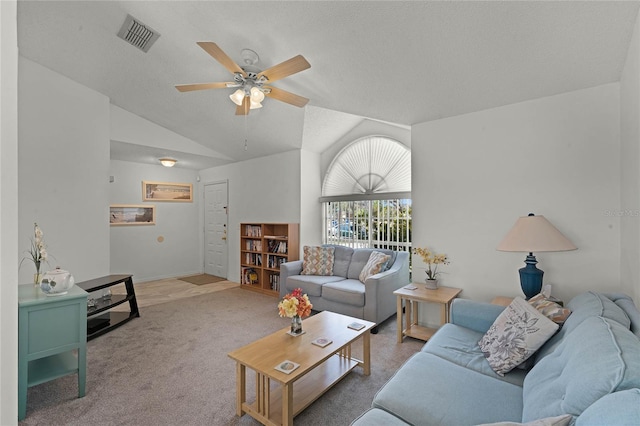 living room featuring vaulted ceiling, carpet flooring, a textured ceiling, and ceiling fan