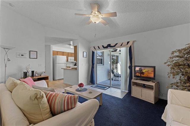 living room with ceiling fan, vaulted ceiling, and a textured ceiling