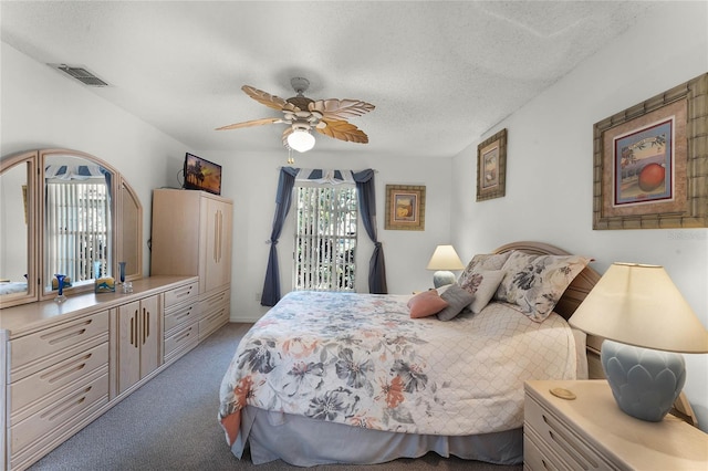 bedroom with light carpet, a textured ceiling, and ceiling fan