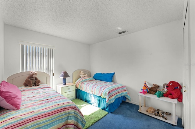 carpeted bedroom with a textured ceiling