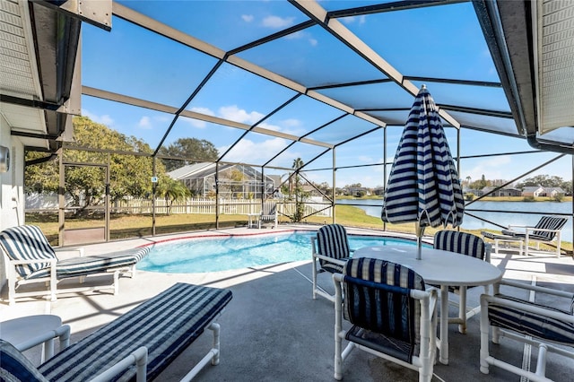 view of pool with a water view, a patio, and glass enclosure