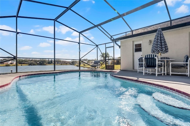 view of swimming pool with a patio, a water view, and glass enclosure