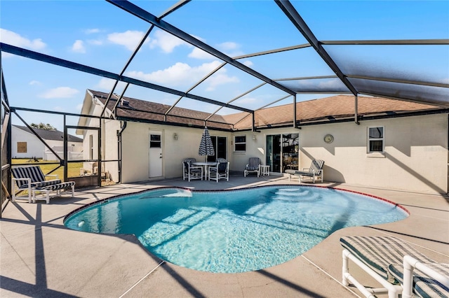 view of swimming pool with a patio and glass enclosure