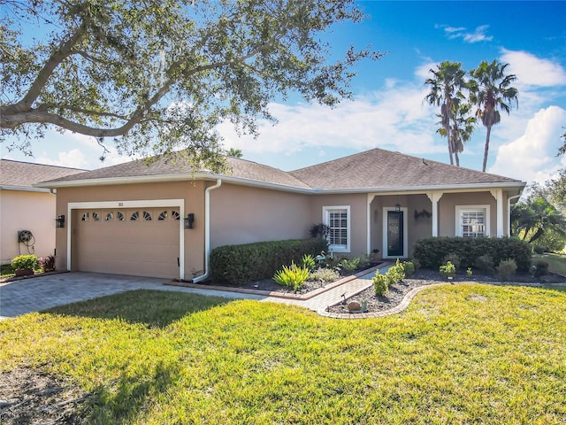 single story home featuring a garage and a front lawn