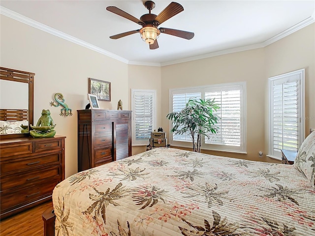 bedroom featuring crown molding, ceiling fan, and hardwood / wood-style floors