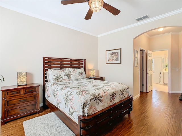 bedroom with hardwood / wood-style floors, ornamental molding, and ceiling fan