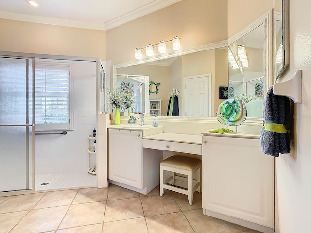 bathroom featuring crown molding, vanity, tile patterned flooring, and a shower