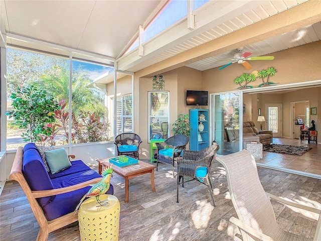 sunroom featuring vaulted ceiling and ceiling fan