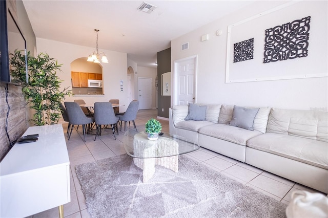 tiled living room with a chandelier