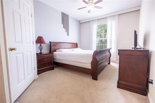 bedroom with ceiling fan and light colored carpet