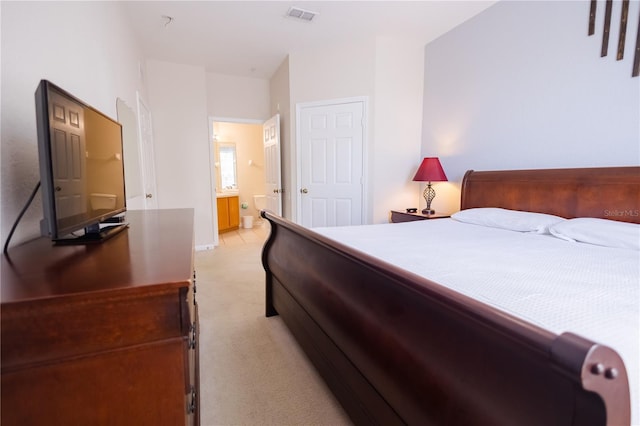 carpeted bedroom featuring ensuite bathroom