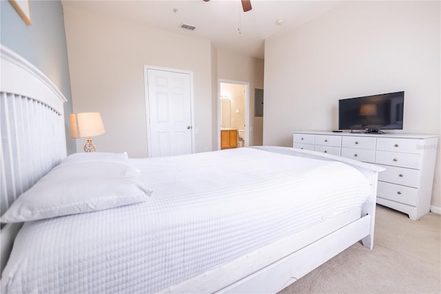 bedroom featuring ceiling fan, connected bathroom, and light carpet