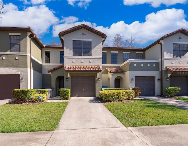 view of front facade with a garage and a front lawn