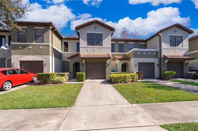 view of front facade with a garage and a front lawn