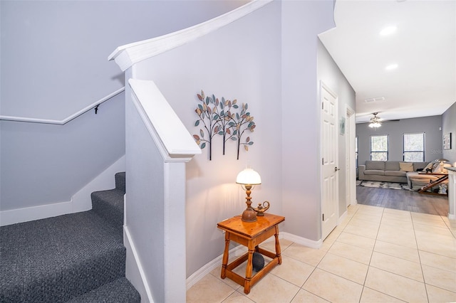 staircase with tile patterned floors and ceiling fan