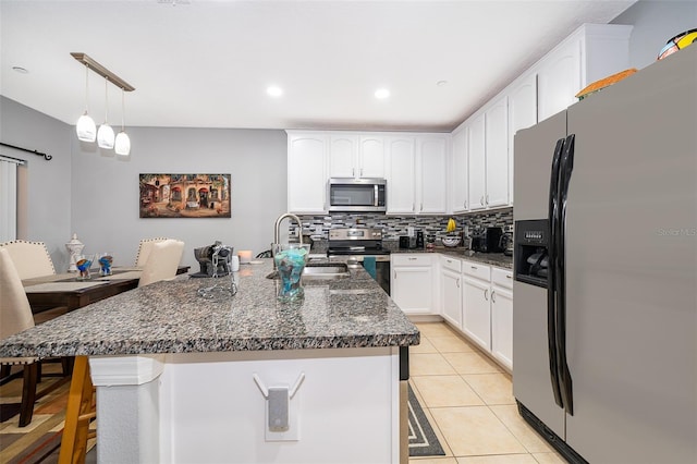 kitchen with sink, white cabinetry, hanging light fixtures, light tile patterned floors, and appliances with stainless steel finishes