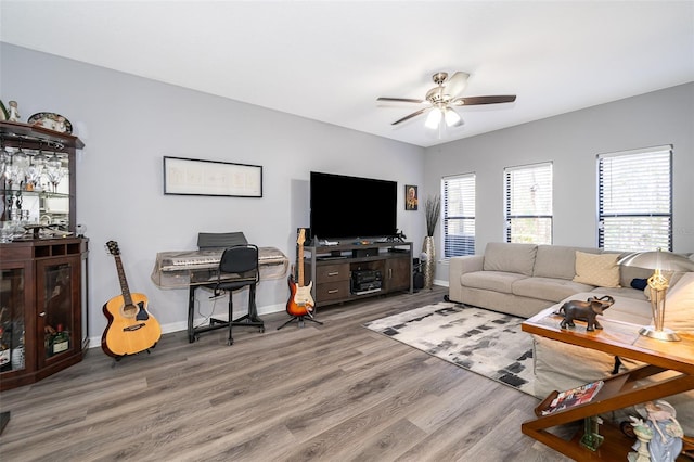 living room featuring hardwood / wood-style floors and ceiling fan