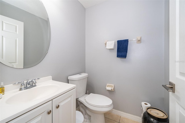 bathroom featuring tile patterned flooring, vanity, and toilet