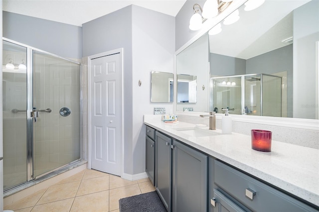 bathroom featuring vanity, an enclosed shower, and tile patterned floors