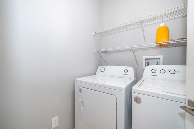 clothes washing area with washer and clothes dryer