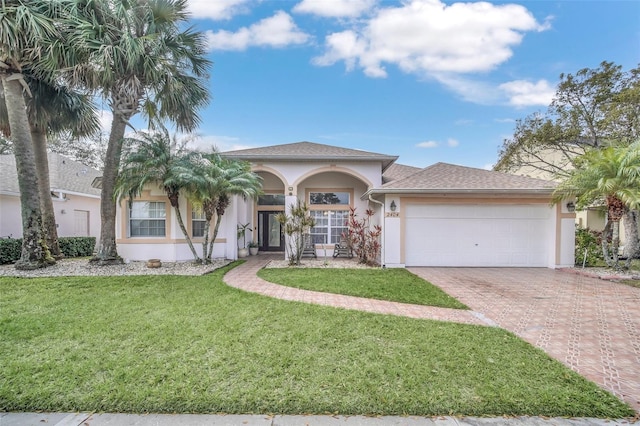 view of front of property with a garage and a front lawn