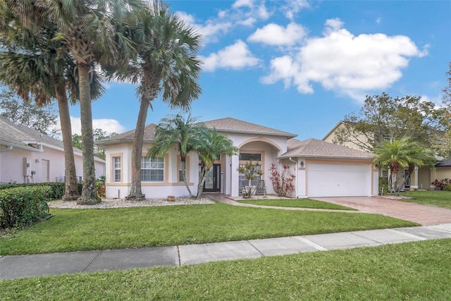 view of front of house featuring a garage and a front lawn