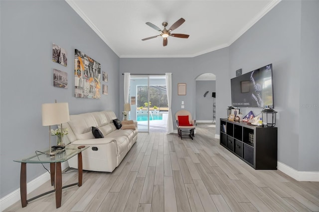 living room with ornamental molding, ceiling fan, and light hardwood / wood-style flooring