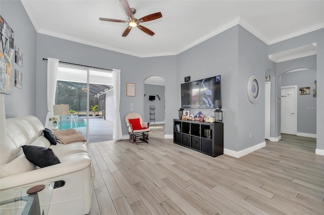 living room featuring crown molding, ceiling fan, and light wood-type flooring