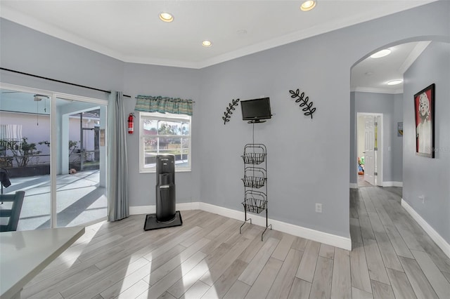 interior space featuring crown molding and light hardwood / wood-style floors