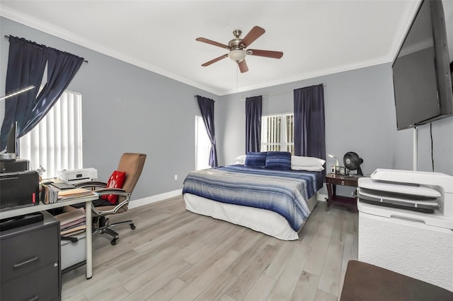 bedroom featuring light hardwood / wood-style flooring, ornamental molding, and ceiling fan