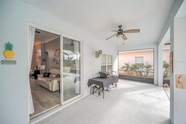 sunroom featuring ceiling fan