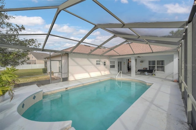 view of swimming pool with a lanai and a patio area