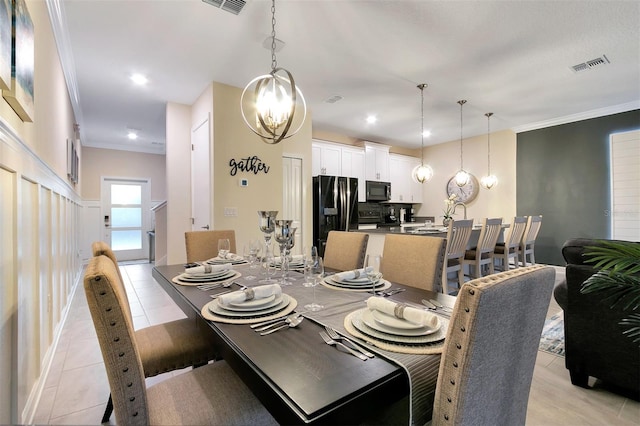 tiled dining room featuring ornamental molding and a chandelier