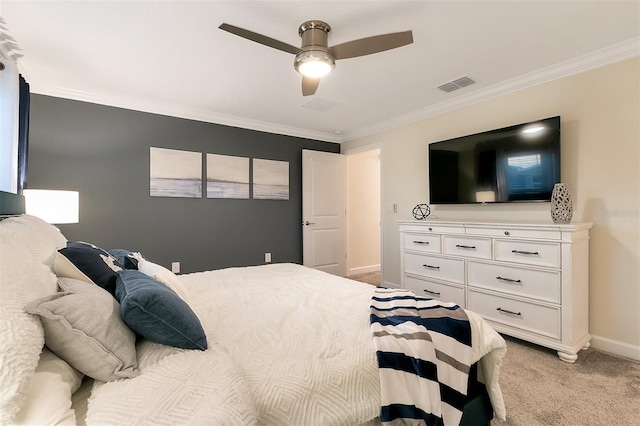 bedroom with crown molding, light carpet, and ceiling fan