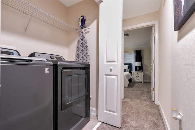 laundry area with light carpet and washer and clothes dryer