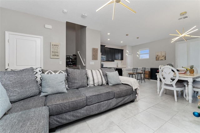 tiled living room featuring a notable chandelier