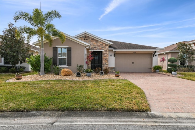 single story home featuring a garage and a front yard