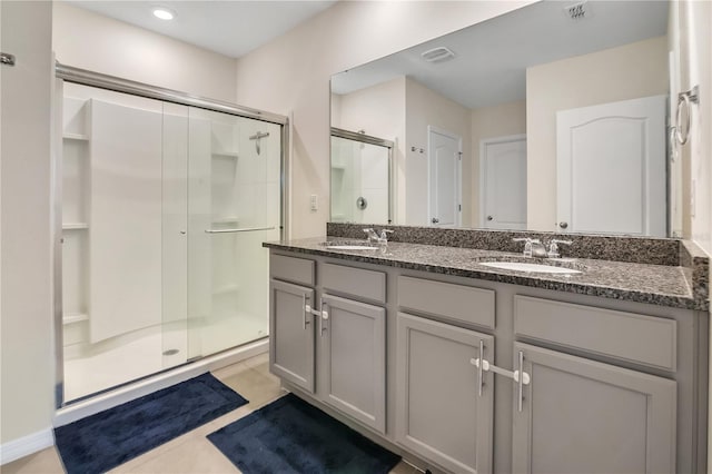 bathroom featuring vanity, an enclosed shower, and tile patterned floors