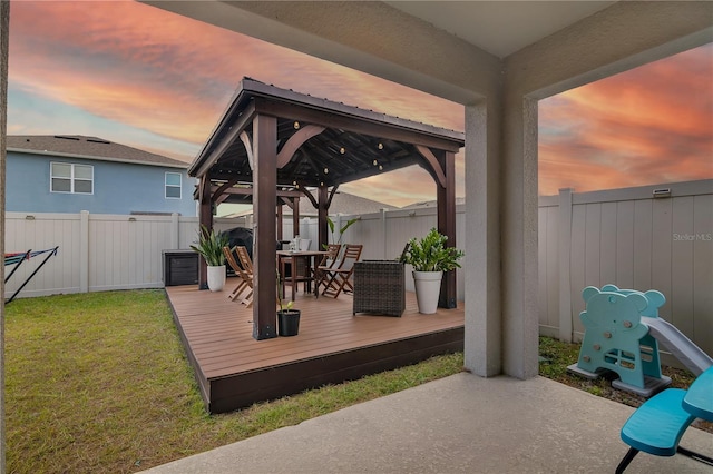 exterior space featuring a gazebo, a lawn, and a deck